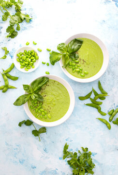 Pureed edamame soup with fresh herbs seasoning, top down view