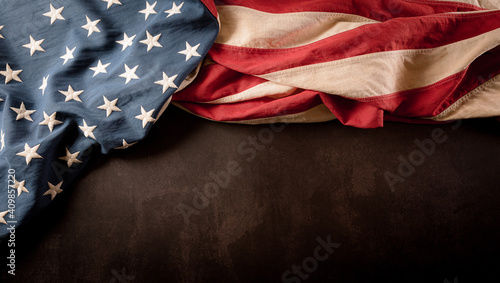Happy presidents day concept with vintage flag of the United States on dark stone background.