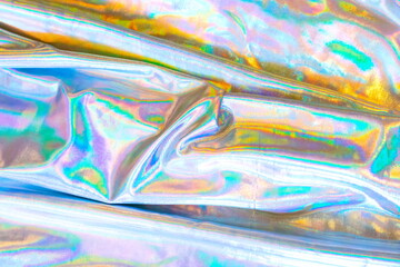 Holographic iridescent mermaid foil texture background. Futurist