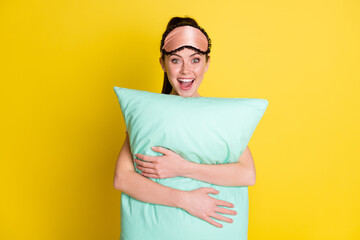 Photo of excited impressed woman dressed nightwear mask open mouth hugging pillow isolated yellow color background