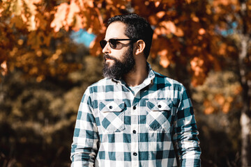 Single man outside in sunglasses plaid clothing autumn fall