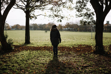 Young woman in garden dusk winter