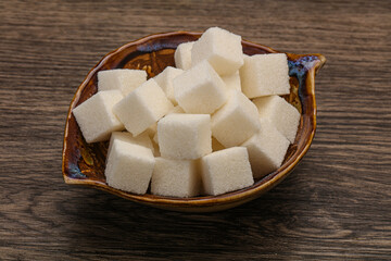 Refined white sugar cubs in the bowl