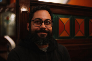 Young man smiling in a pub