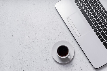 workplace. copyspace. top view. laptop keyboard next to a small cup of espresso coffee