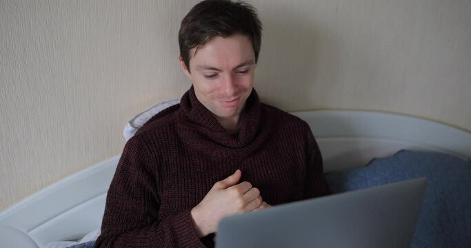 Man showing thumbs down gesture looking something insipid in a laptop