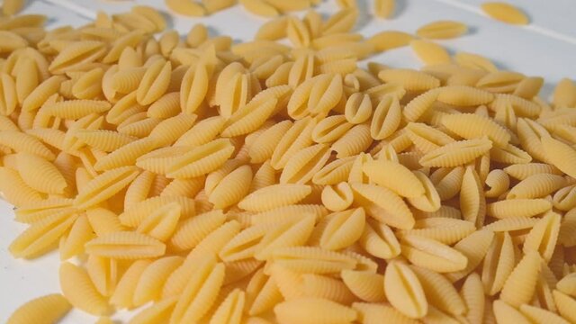 Italian pasta concept. Uncooked raw Italian gnocchetti sardi pasta background.