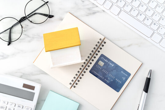 Top view of estimating and paying house tax with credit card.