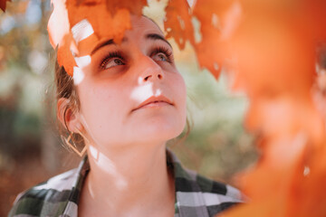Woman under leafs in fall