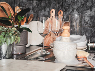 Various dishes in soapy foam on the sink in the kitchen