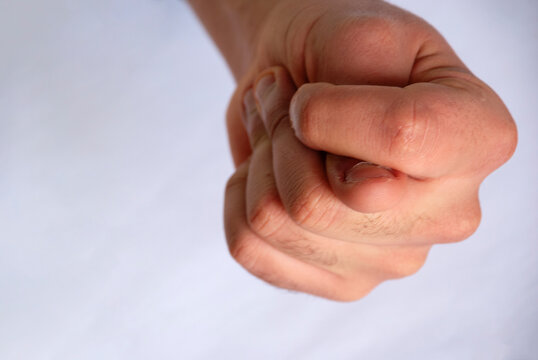A human hand shows a fig sign to the camera.