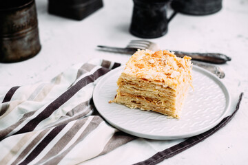 Napoleon cake in a plate on the table