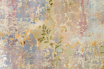 old grunge wall of an old house with remaining color