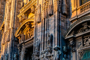 Fototapeta premium Statues on Milan Duomo facade in sunset light