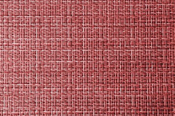Texture of a red wicker surface. Red background for text and design. Braided texture
