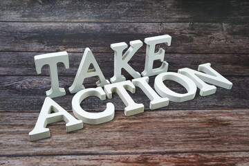 Take Action Word alphabet letters on wooden background