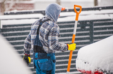 Men Removing Snow During Heavy Snow Fall