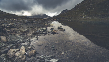 Gloomy scene of alpine moumtain lake