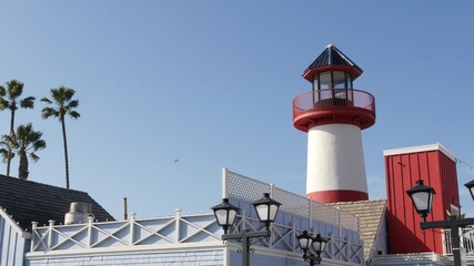 Retro lighthouse, tropical palm trees and blue sky. Red and white vintage old-fashioned beacon....