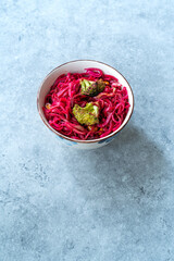 Obraz na płótnie Canvas Beetroot Pad Thai Rice Noodles with Beet Flavored and Broccoli in Bowl.
