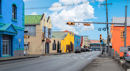 Traffic street and colorful buildings in city centre of Bridgetown, Barbados. - obrazy, fototapety, plakaty