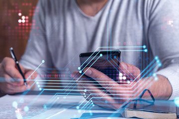 A client is signing the contract to create a software to present it at start up conference and gain investments for innovative service. Checking the details at smartphone. Hologram tech graphs.