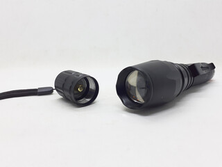 Black Electric LED Flashlight Powered by Rechargeable Battery in White Isolated Background