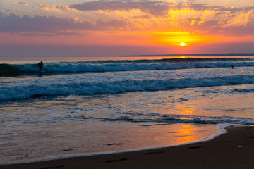 Fototapeta na wymiar Amazing sunset sea scenery with waves and sandy beach