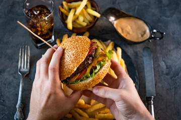 male hands holding tasty burger