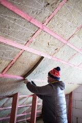 A man insulates an attic