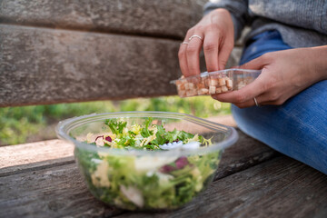 girl eating salad in nature