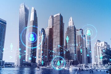 Skyscrapers of Dubai business downtown. International hub of trading and financial services. Social network icons hologram, concept of people connection. Double exposure. Dubai Canal waterfront.