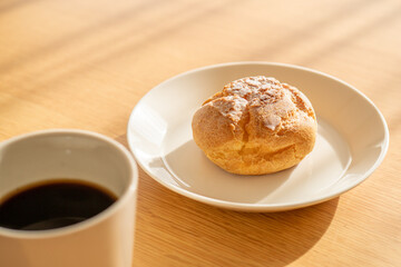 A cream puff and a cup of coffee