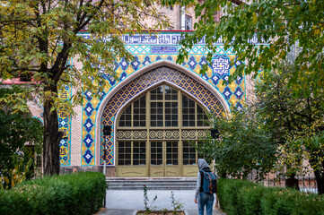 Yerevan, Armenia - November 1, 2019: Girl in head scarf in the inner yard of the Blue Mosque in Yerevan, Armenia - 409876095