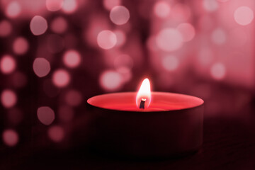 Pink candle close-up on bokeh background