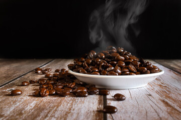 Hot roasted coffee beans in a white plate