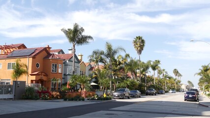 Fototapeta na wymiar California typical suburban street, tropical Oceanside USA. Different colorful houses row. Generic american homes, buildings facade, townhouse exterior architecture. Residential district real estate.