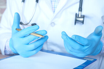 doctor hand in protective gloves writing prescription, 