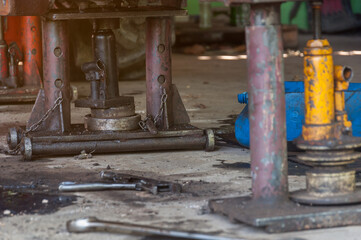 Jack is lifting the car to perform various repairs on the car.