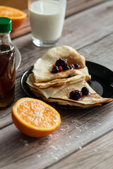 
Homemade pancakes, delicious thin pancakes with berries and maple syrup