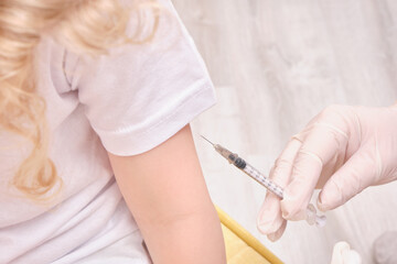 A doctor makes a vaccination to a child
