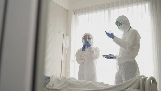 Doctor and nurse prepare vaccine shot for injection to asian patient.