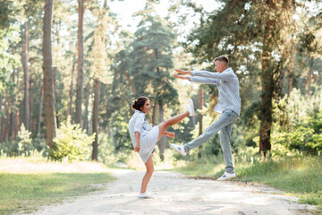 young couple in love having fun and enjoying the beautiful summer nature. woman and man, wearing in denim outfit are having date outdoors in the park. Romantic relationship. valentines day