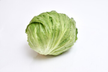 swing of fresh iceberg lettuce on white background