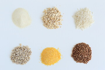 different cereals are poured on a white surface
