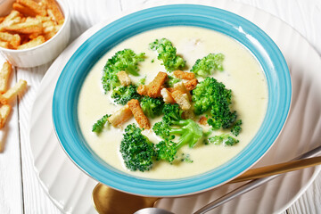 cream soup with broccoli and croutons in a bowl