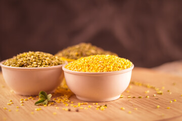 Broken Mung Lentils (Moong Dal) spilled on agriculture background,green moong dal in bowl,Peeled Green Beans.