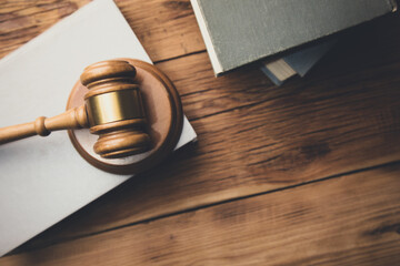 law book with a wooden judges gavel