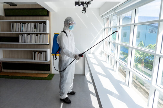 Male medical staff wearing PPE uniforms to prevent COVID-19 from using a nebulizer. And use chemicals to disinfect at the library, reading room, to prevent the risk of coronavirus outbreak.