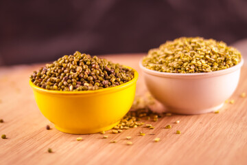 Raw Organic moong bean heap in yellow Bowl with selective focus,vigna radiata, green beans or moong dal,dry organic Moong Whole Dal or Mung bean